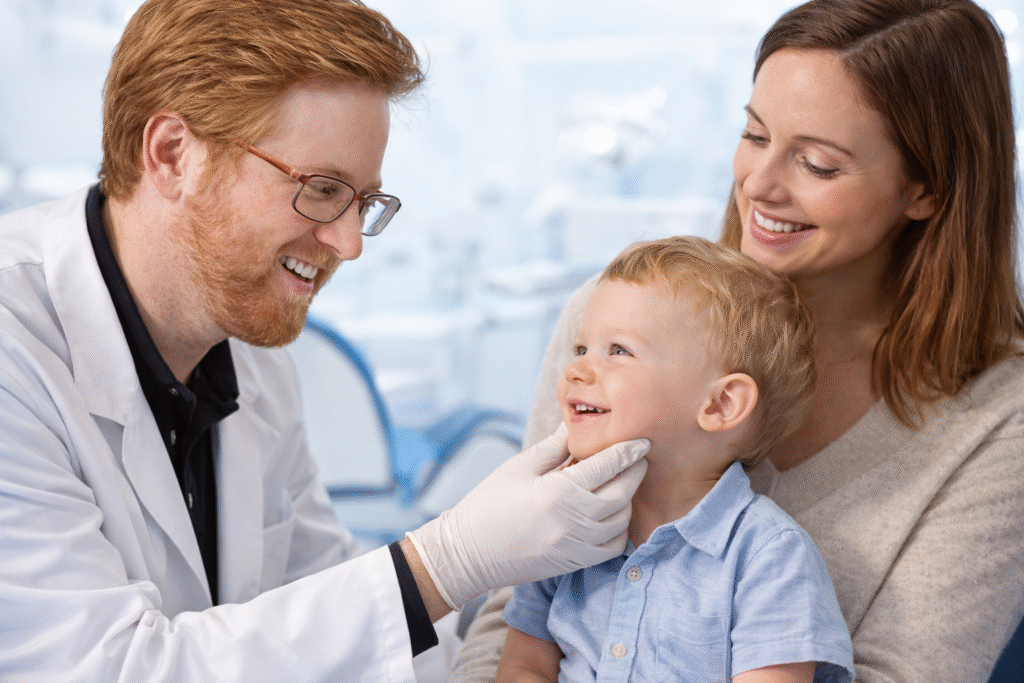 Pediatric dentist examining toddler for lip tie laser therapy in Des Peres MO